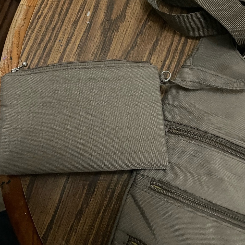 A large gray baggallini purse with attached coin purse. It has card holder.